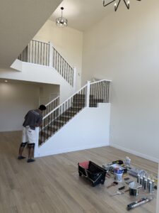 Man painting stairs inside home | The Paint Masters