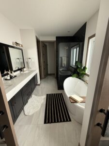 Spacious bathroom with black cabinets | The Paint Masters