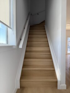 Wooden stairway by bright window | The Paint Masters