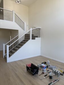 Room with stairs and paint supplies | The Paint Masters