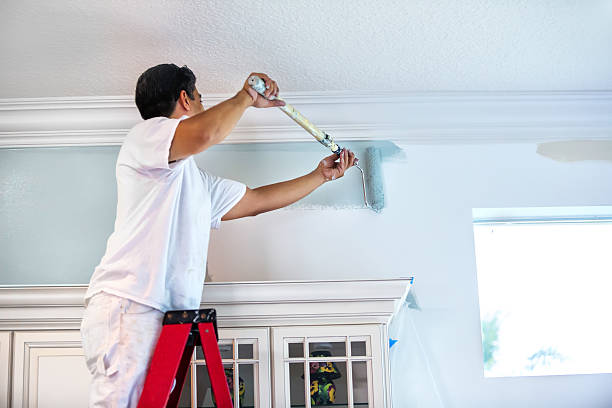 Man painting ceiling with roller | The Paint Masters