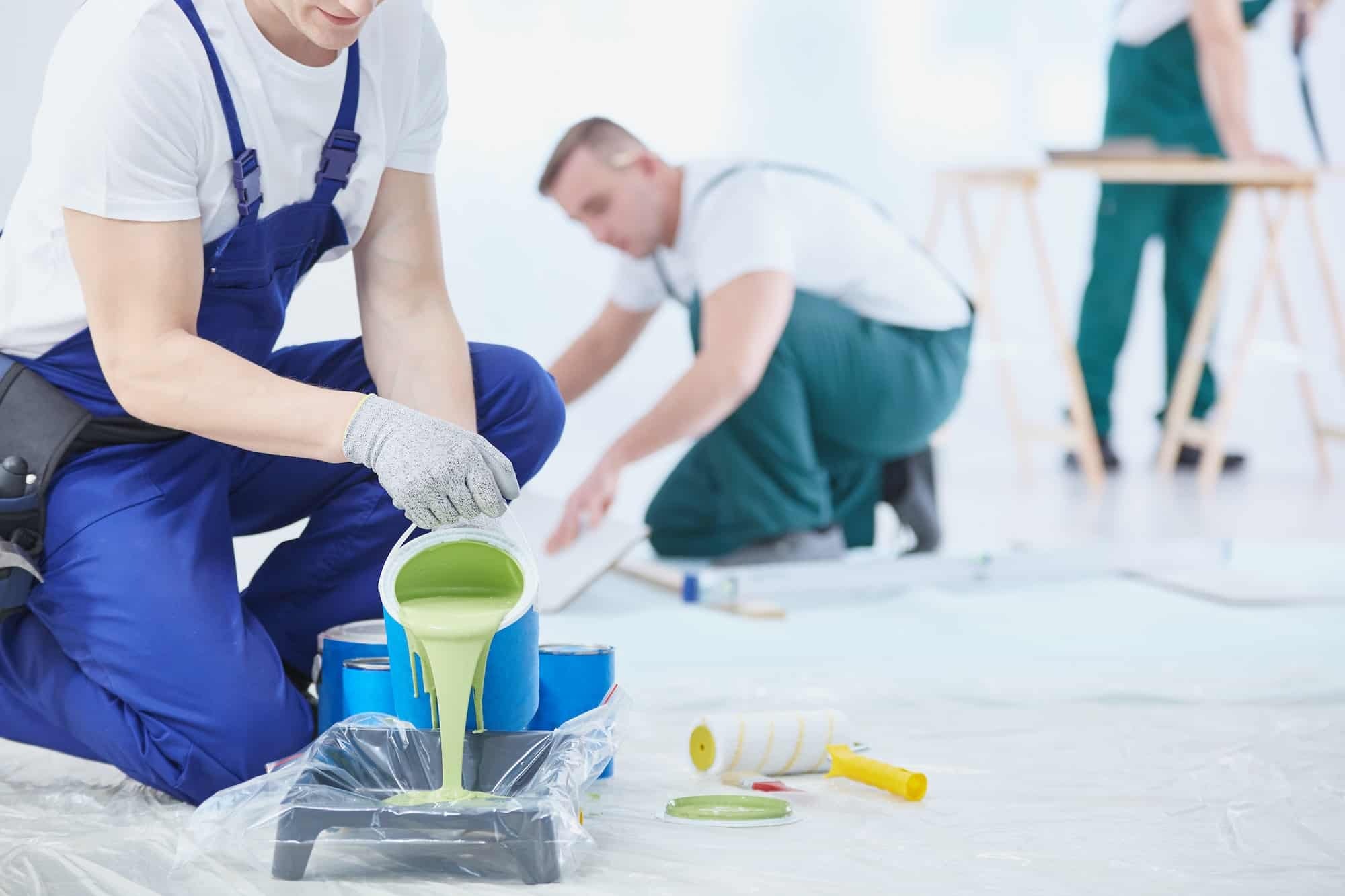 Man painting room with brushes | The Paint Masters