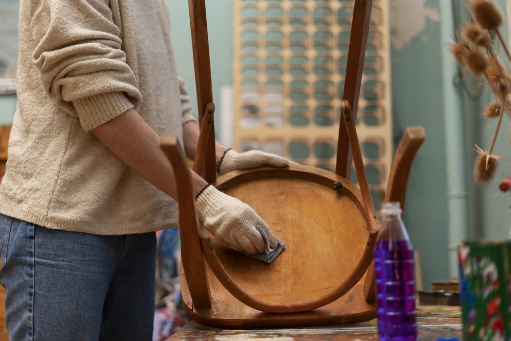 Person painting wooden chair | The Paint Masters
